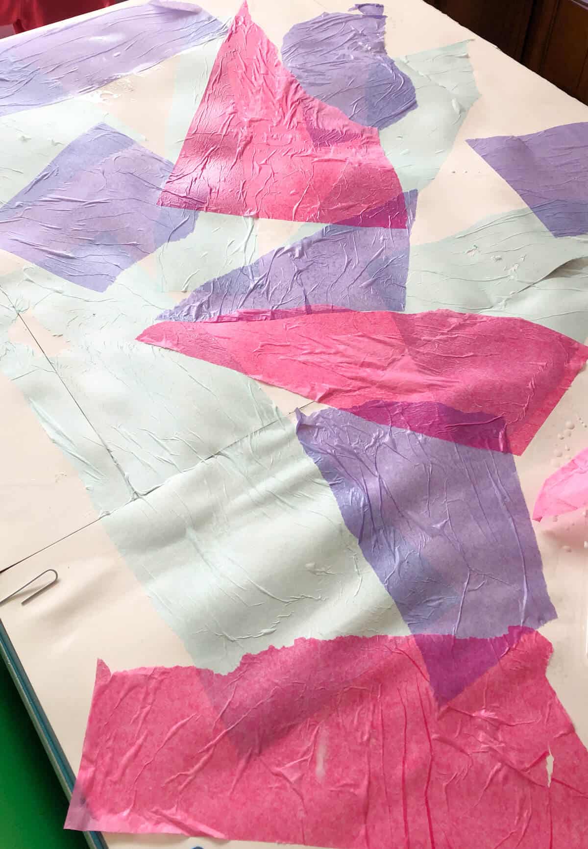 tissue paper shapes collaged on white paper