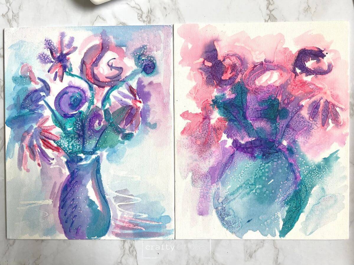 2 different flower glue resist watercolor paintings on canvas boards.