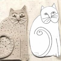 clay slab art project for kids with paper cat template and clay cat on placemat.