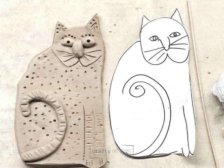 clay slab art project for kids with paper cat template and clay cat on placemat.