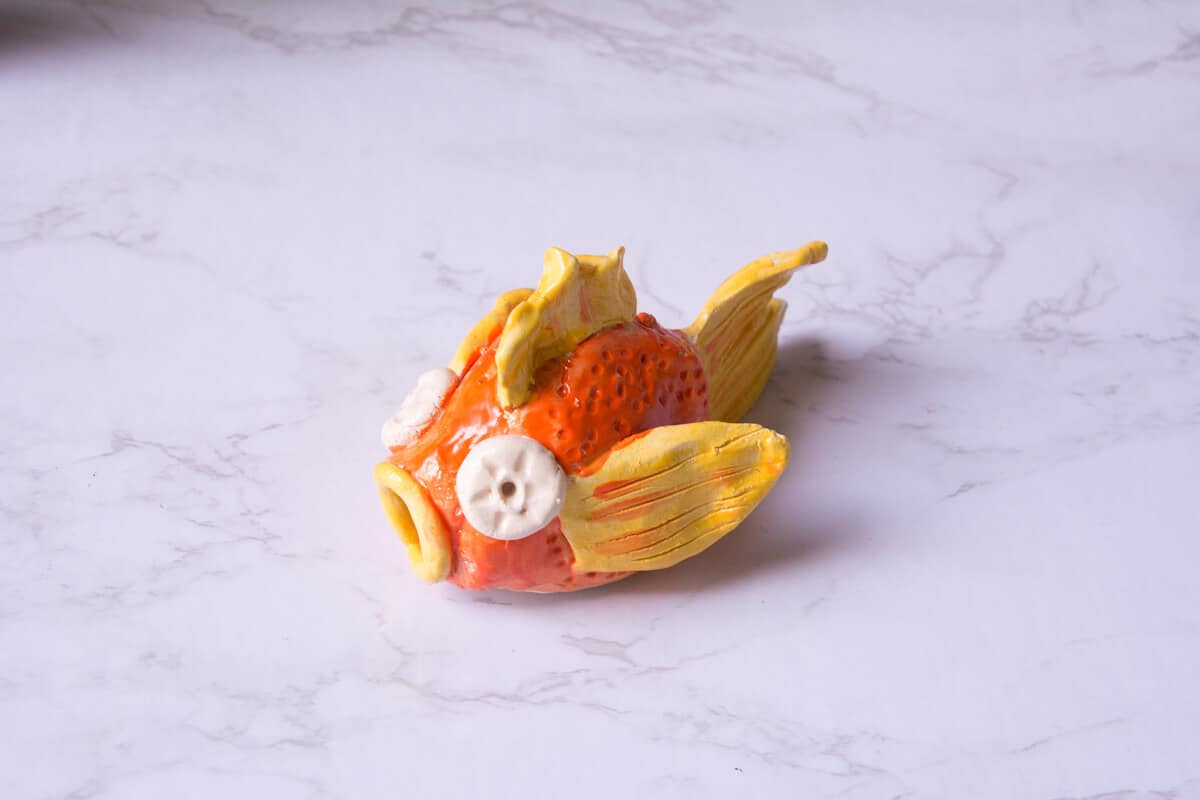 orange and yellow glazed ceramic fish project for kids.
