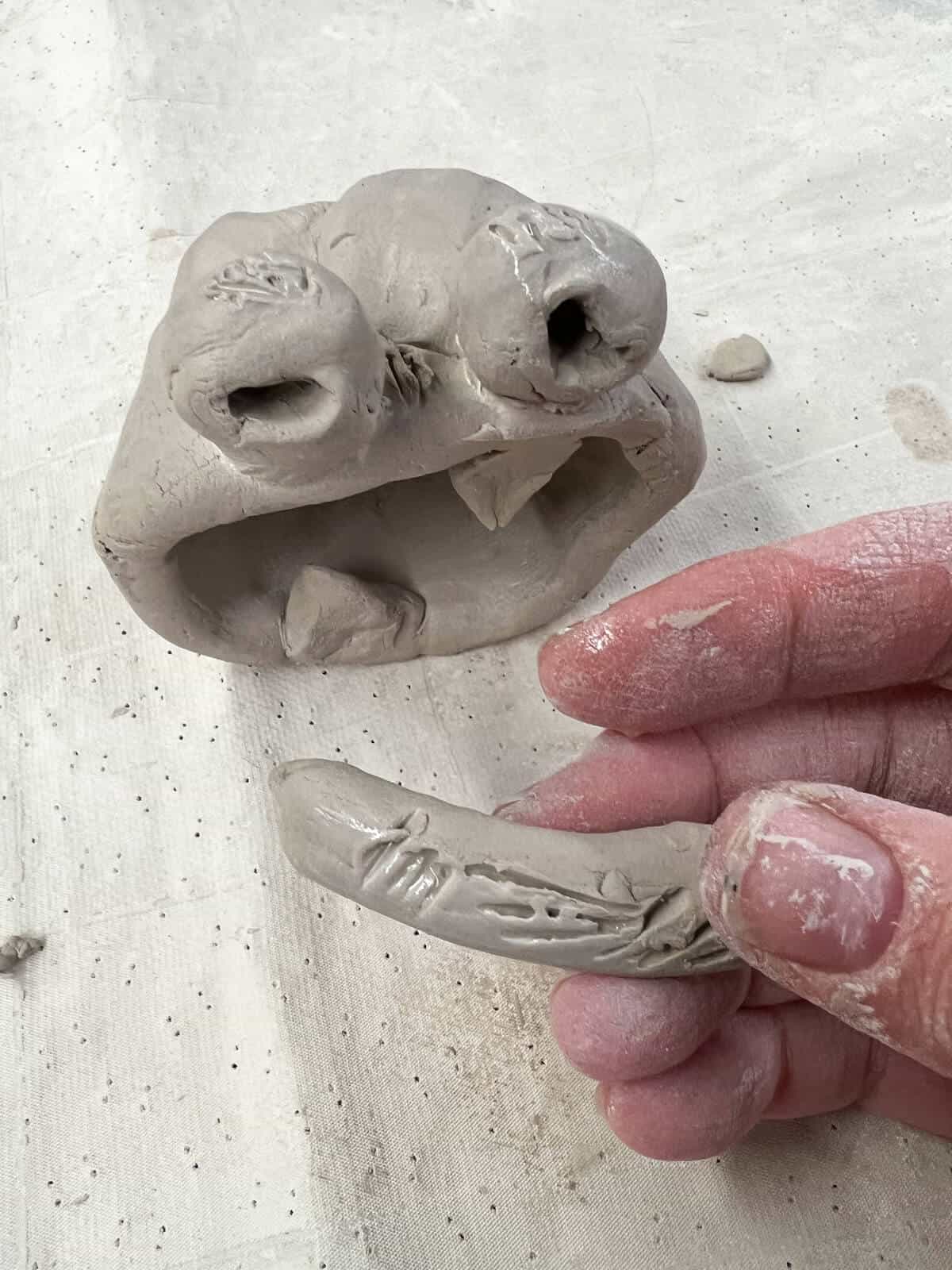 eyebrow for clay monster scored on to clay project.