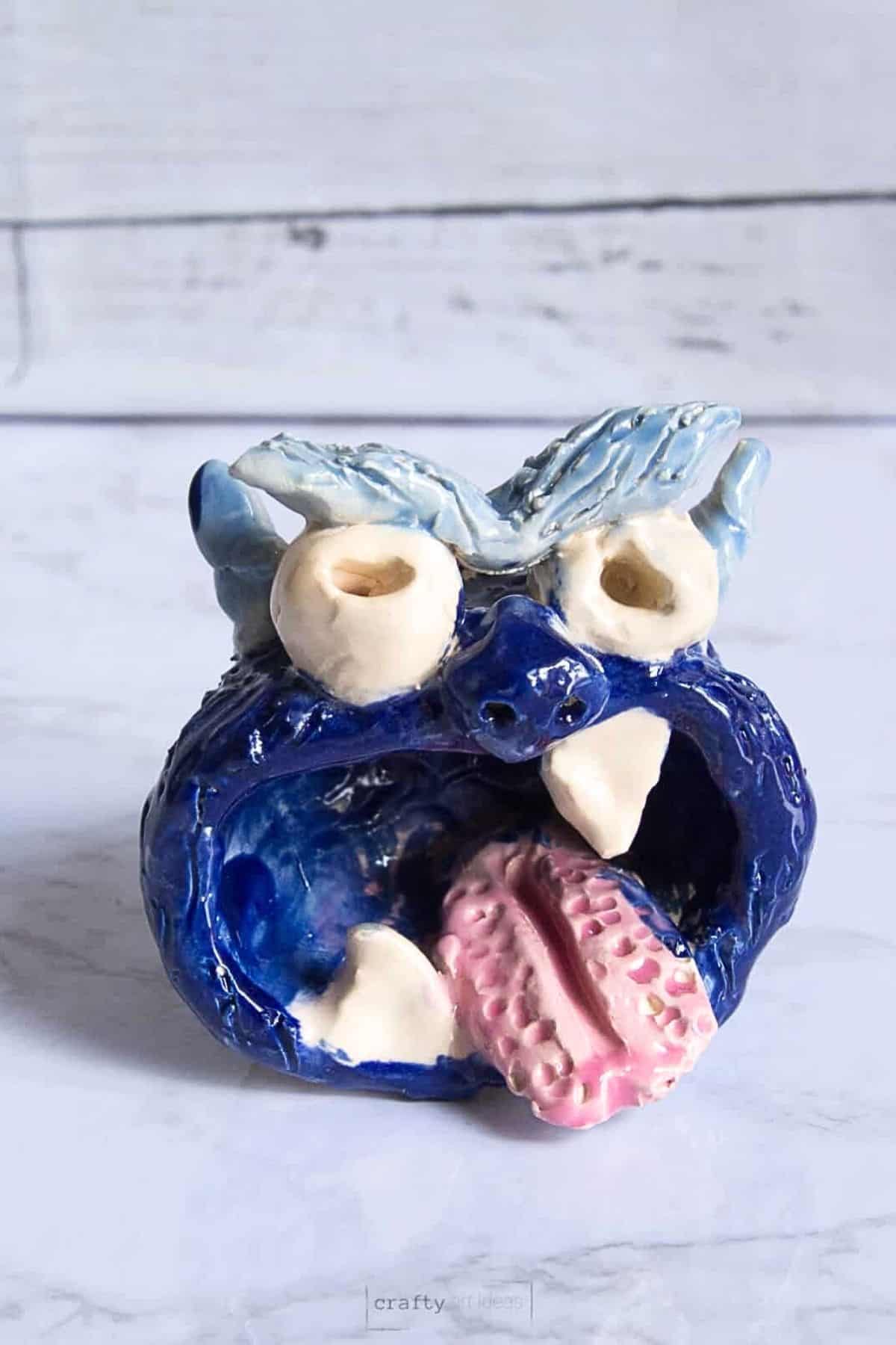 blue glazed pinch pot monster clay project for kids.
