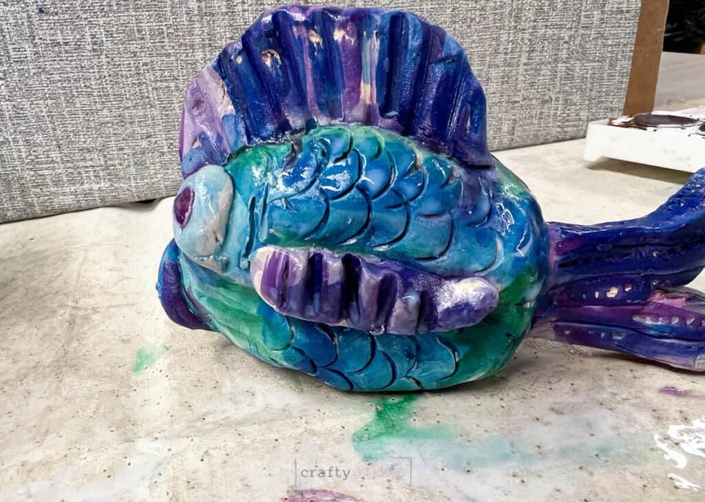 watercolor painted clay fish spray with clear coat.