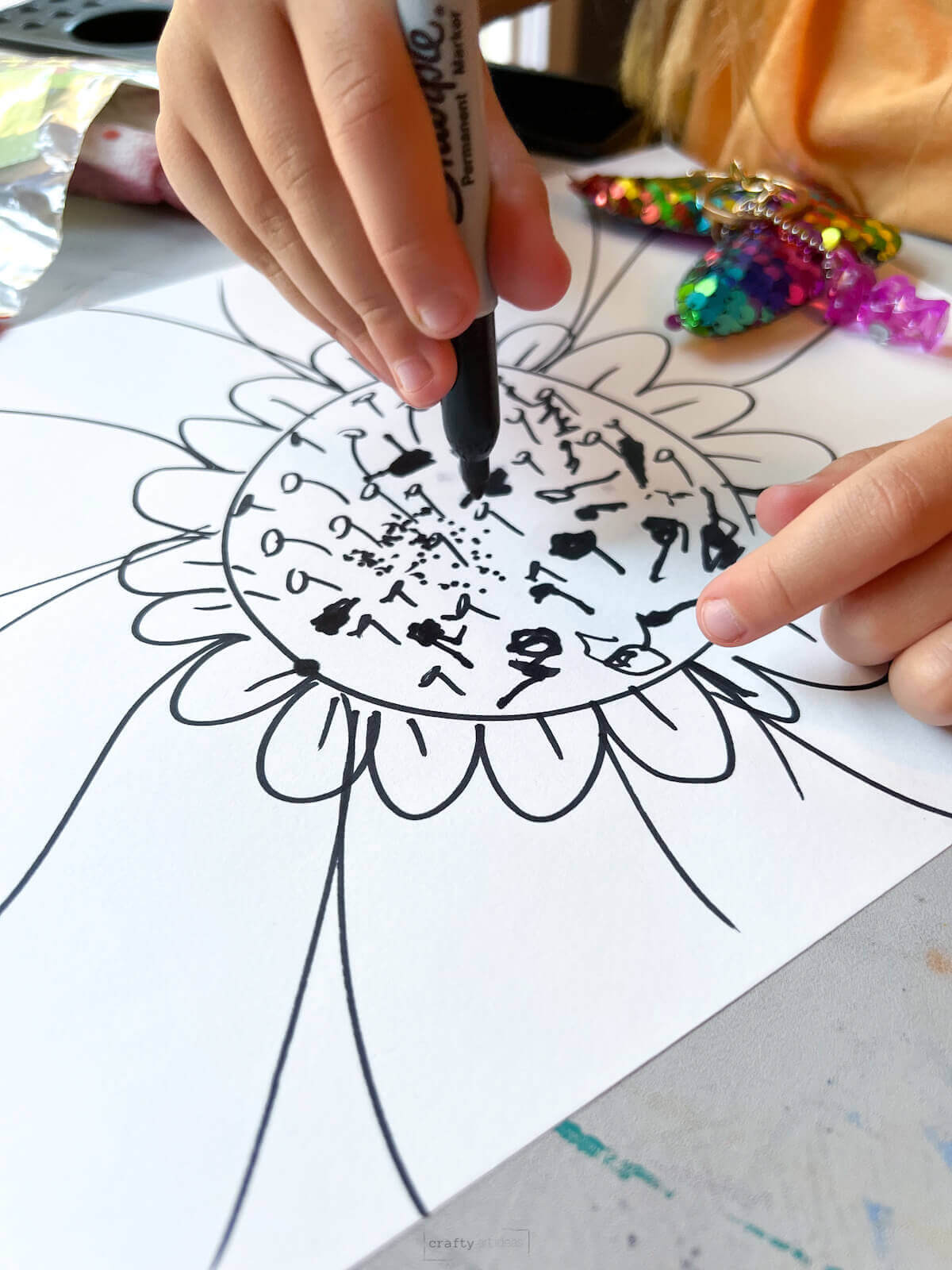 child hand drawing large zoomed in flower craft.