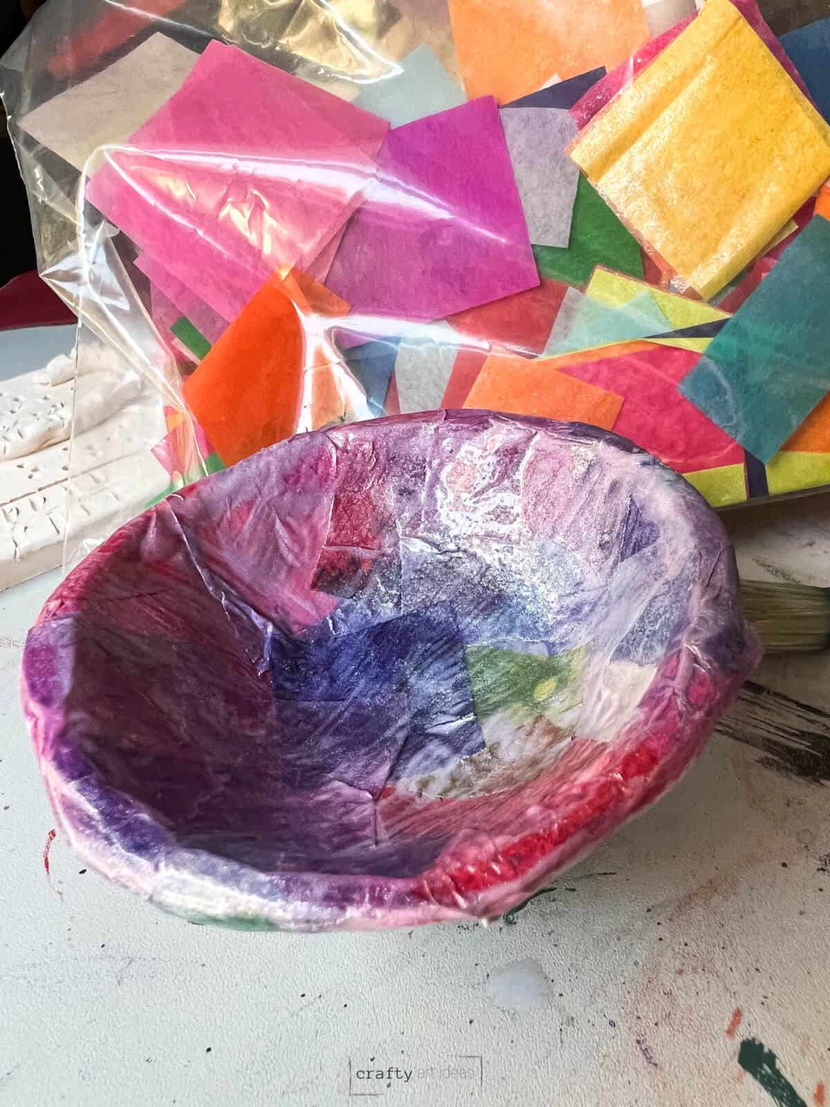clay pinch pot with decoupage tissue paper and gloss medium on top.