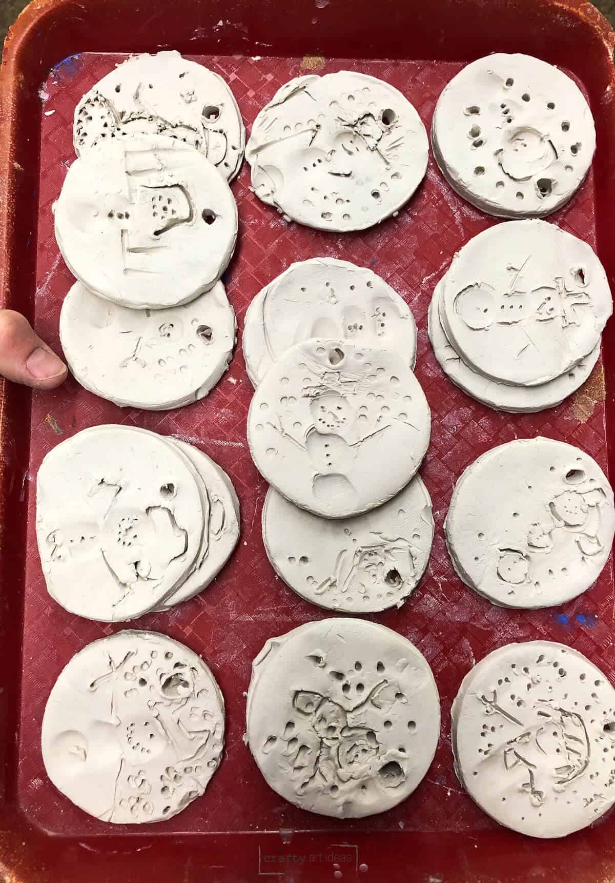 tray of clay snowmen ornaments made by young children.