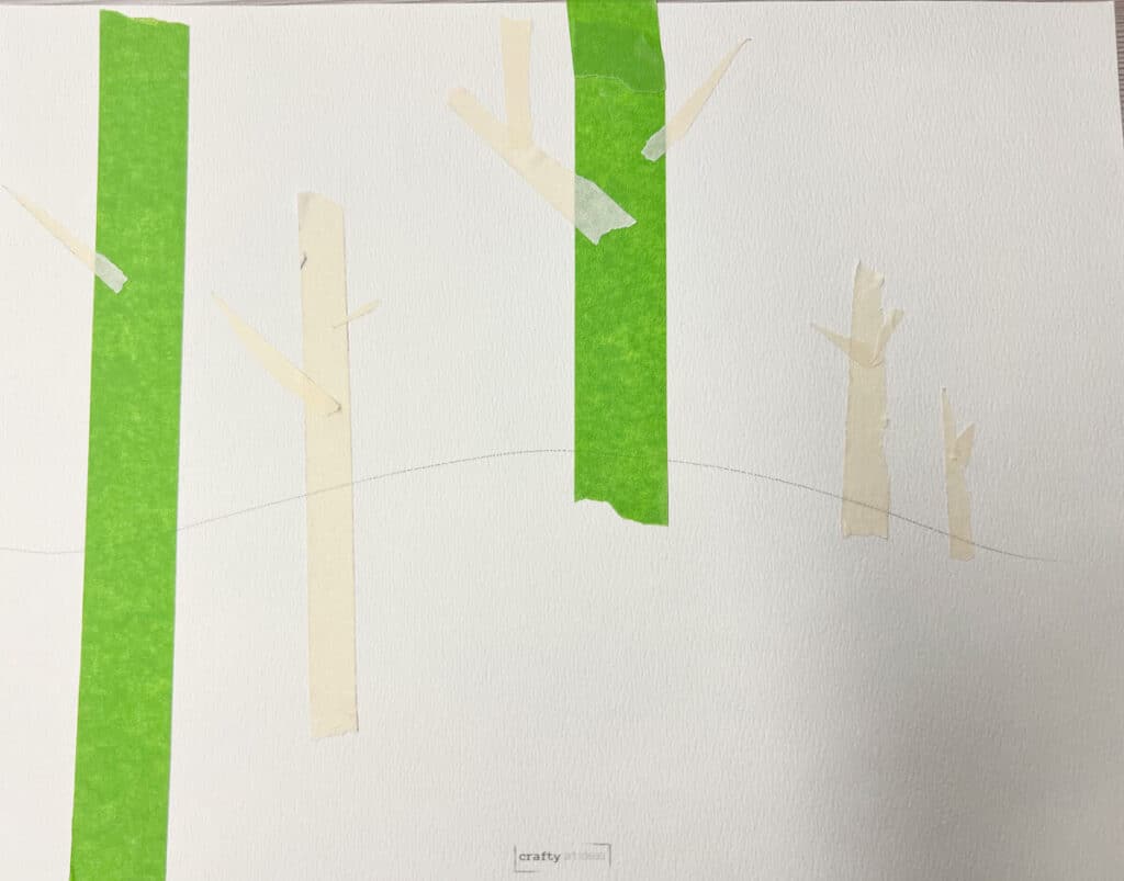 painter's tape and masking tape on watercolor paper to make trees.