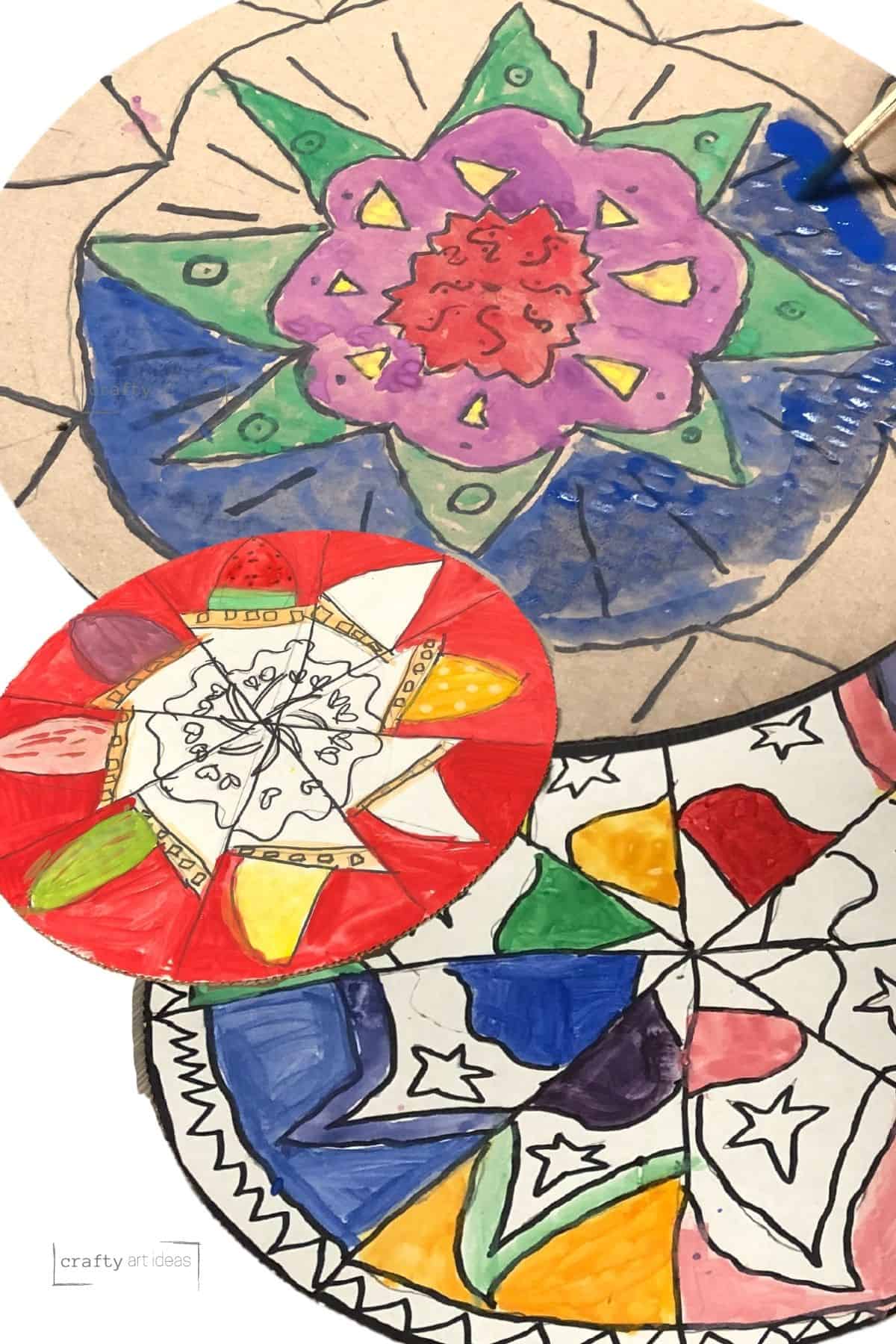 3 different mandala art projects by kids on cardboard circles.