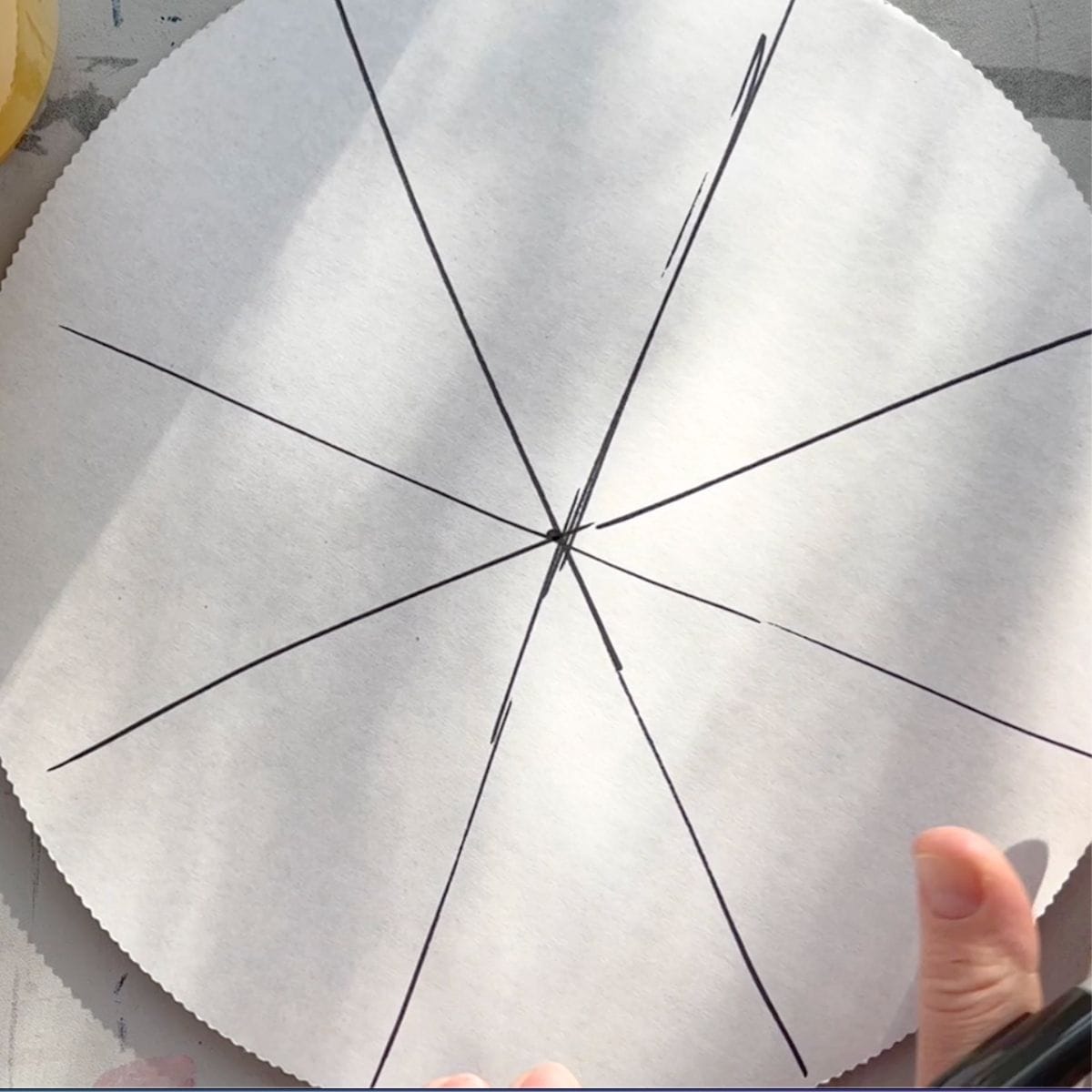 cardboard circle with 8 sections made by drawn lines.