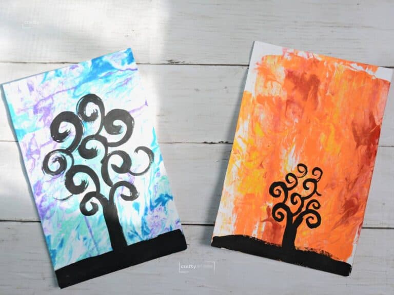 2 different tree of life paintings on different marbled backgrounds.