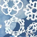 5 different paper snowflakes on blue background.