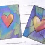 2 different heart artworks done with chalk pastels on black paper.