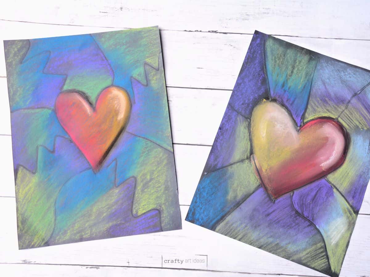 2 different heart artworks done with chalk pastels on black paper.