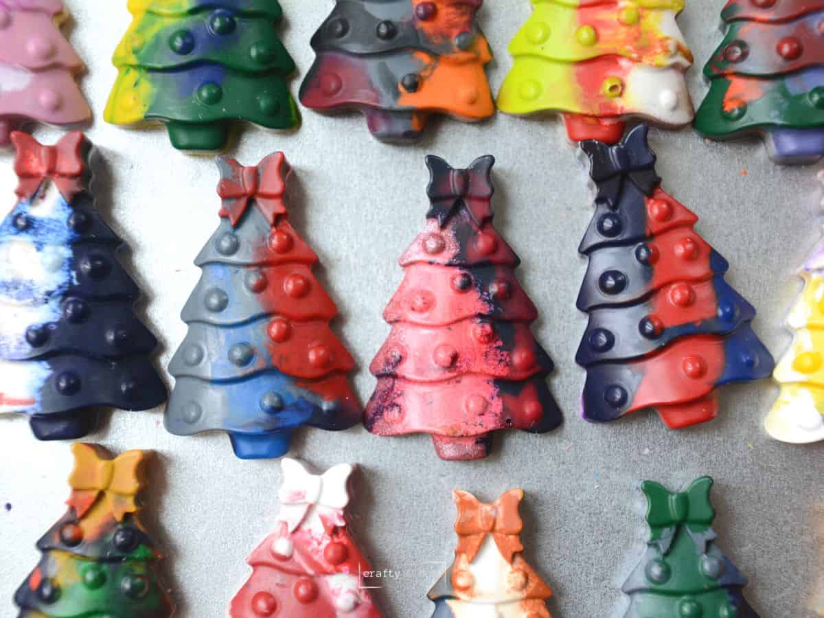 colorful Christmas tree crayons on silver cookie sheet.