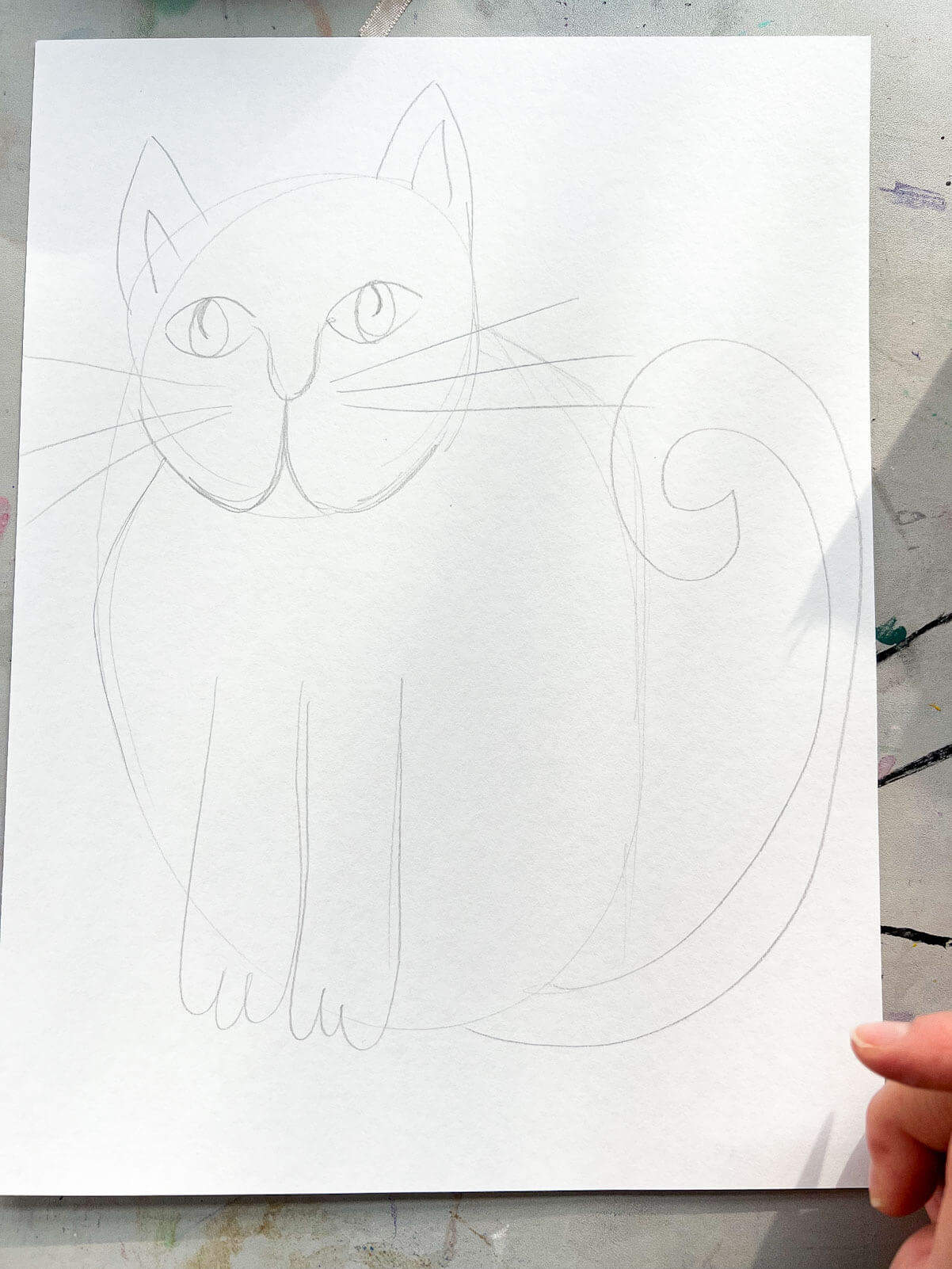 easy cat drawing sketched on white paper.