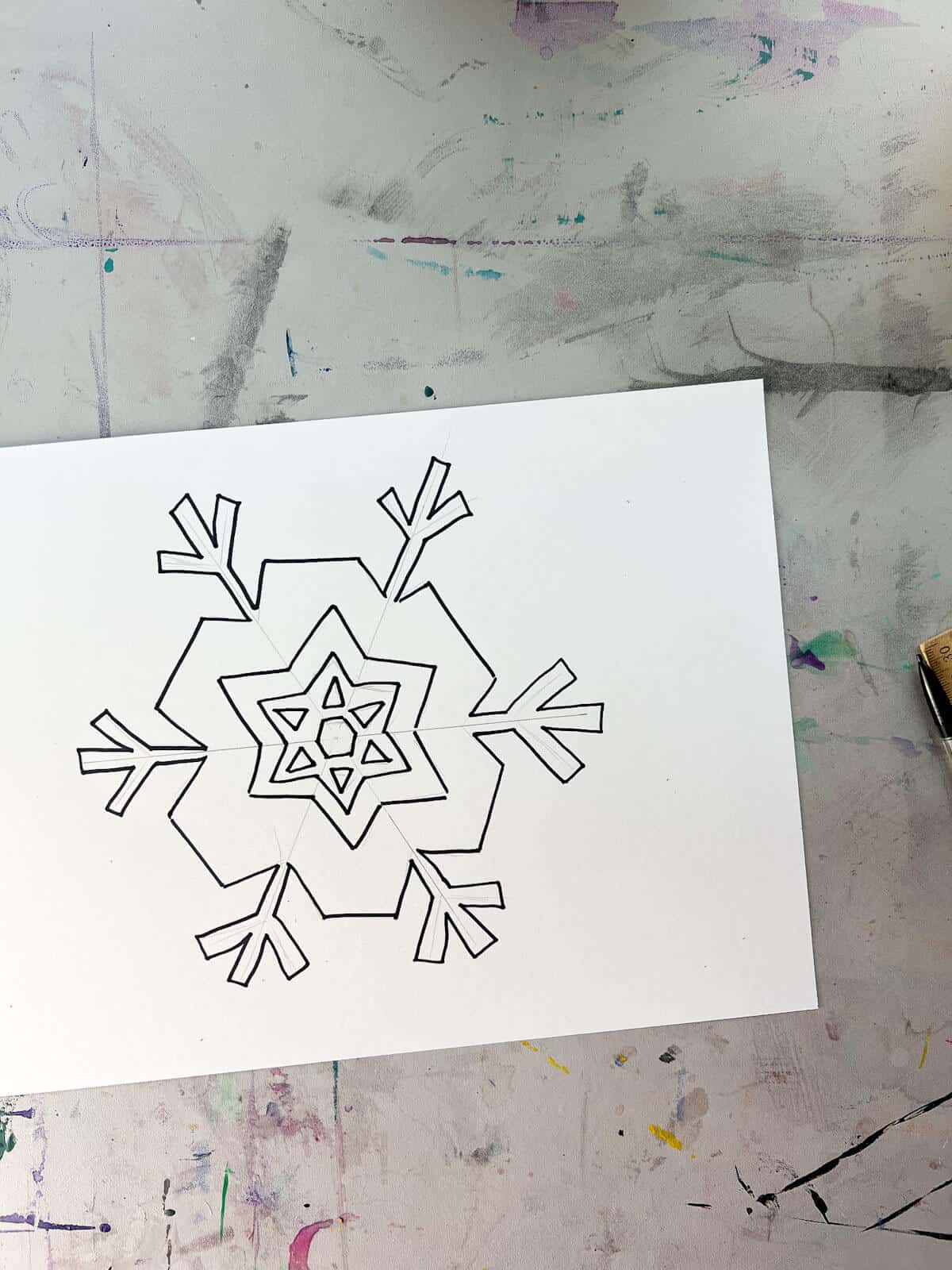 snowflake drawing outlined with black marker.