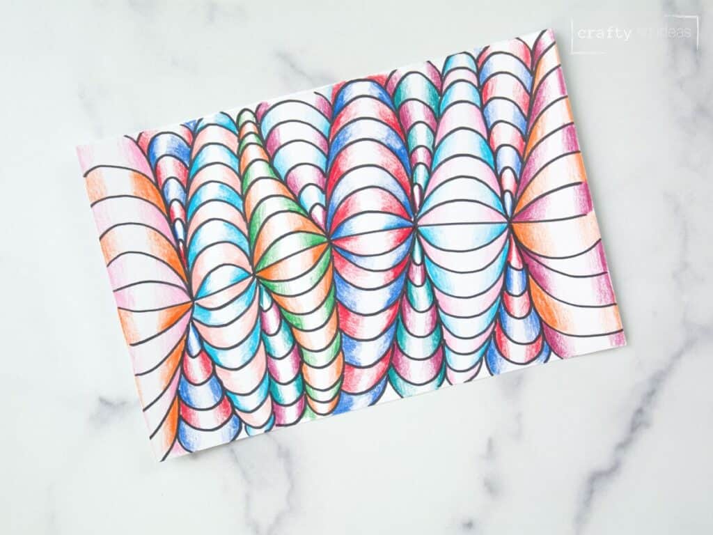 colored pencil and marker optical art on marble table.