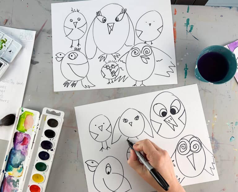 hand drawing cartoon birds on art table.