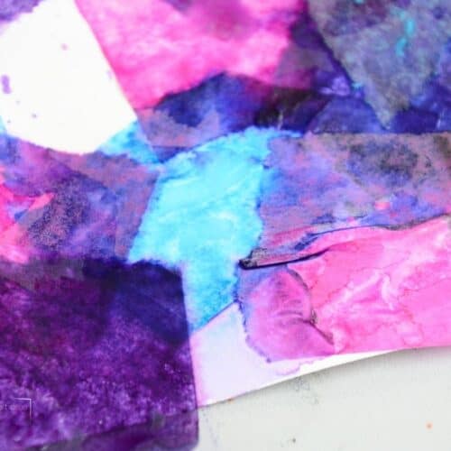 blue, purple and pink wet tissue paper on white paper.