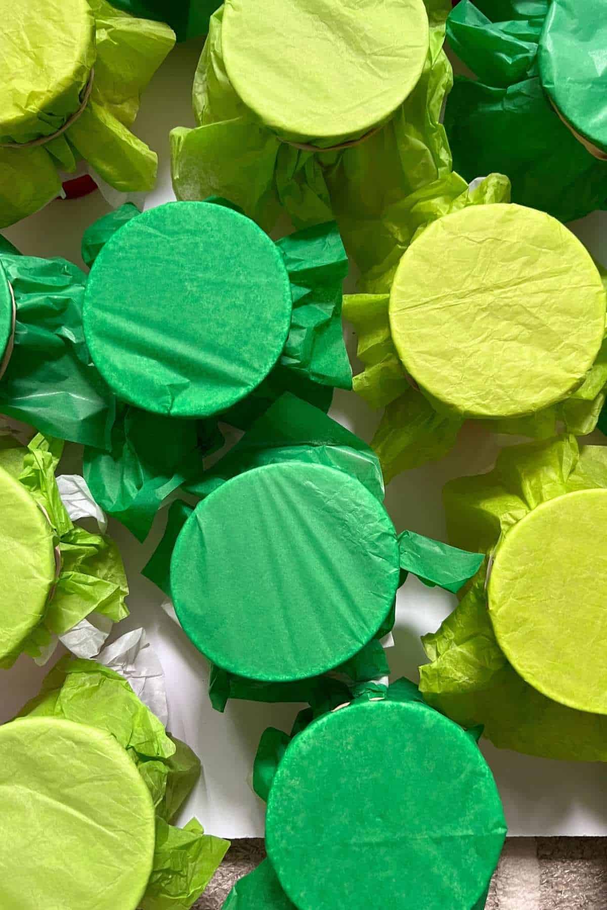 green tissue paper covered cups.