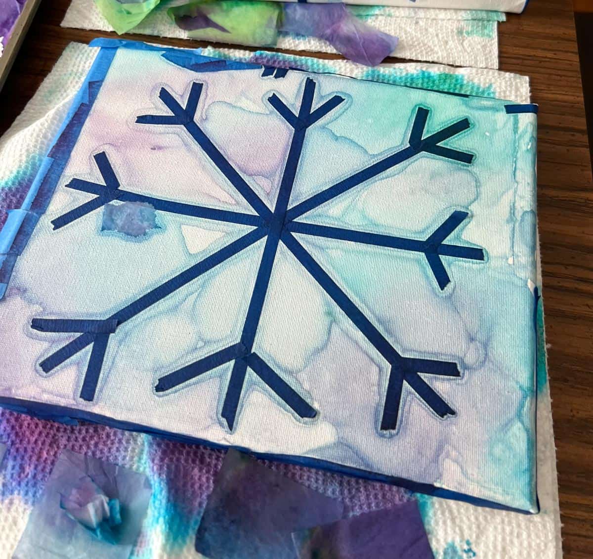 watercolor looking painted in background of a snowflake.