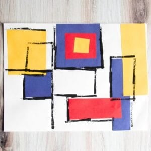 Blue, red, and yellow paper squares with black lines.