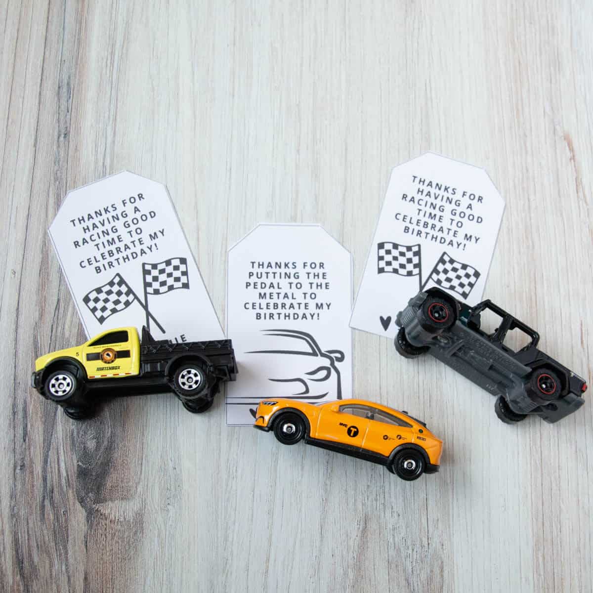 toys cars on top of printable car favor bag tags.