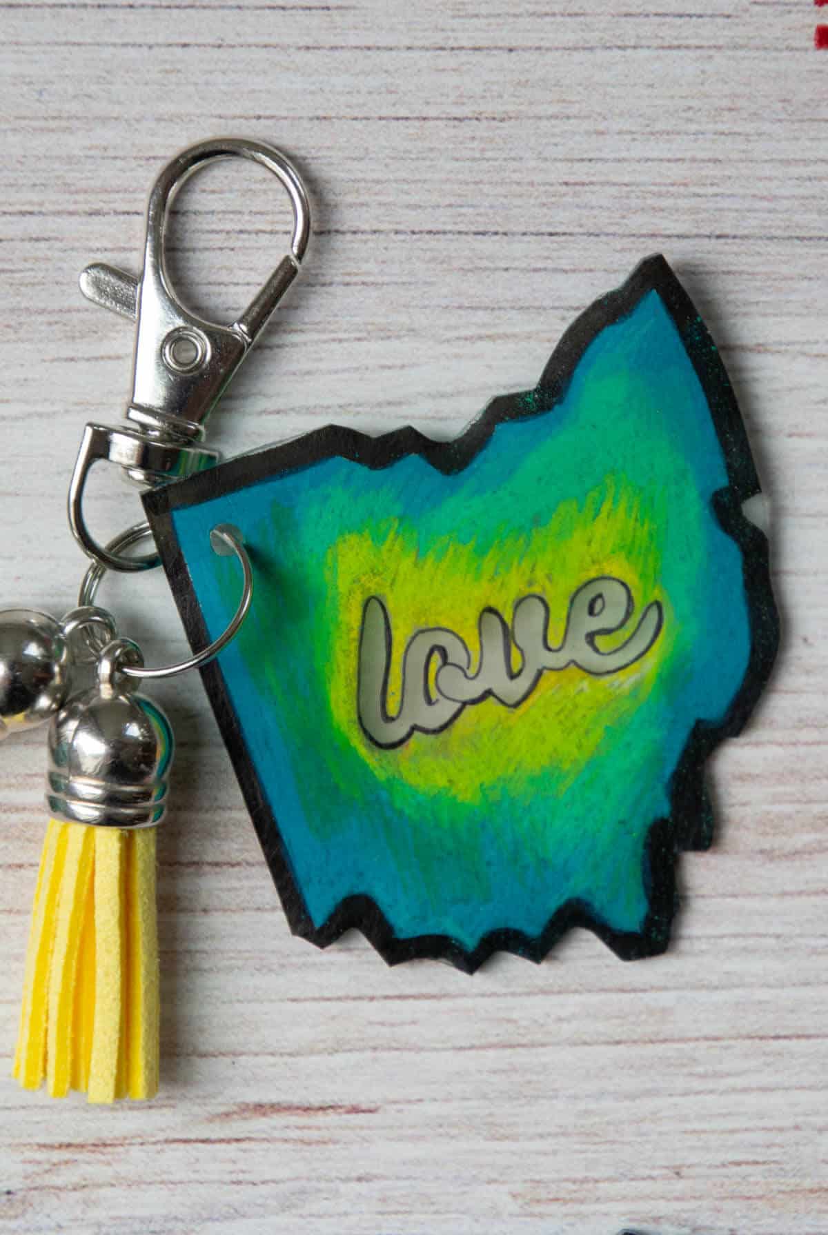 green, yellow and blue colored plastic shaped Ohio keychain.