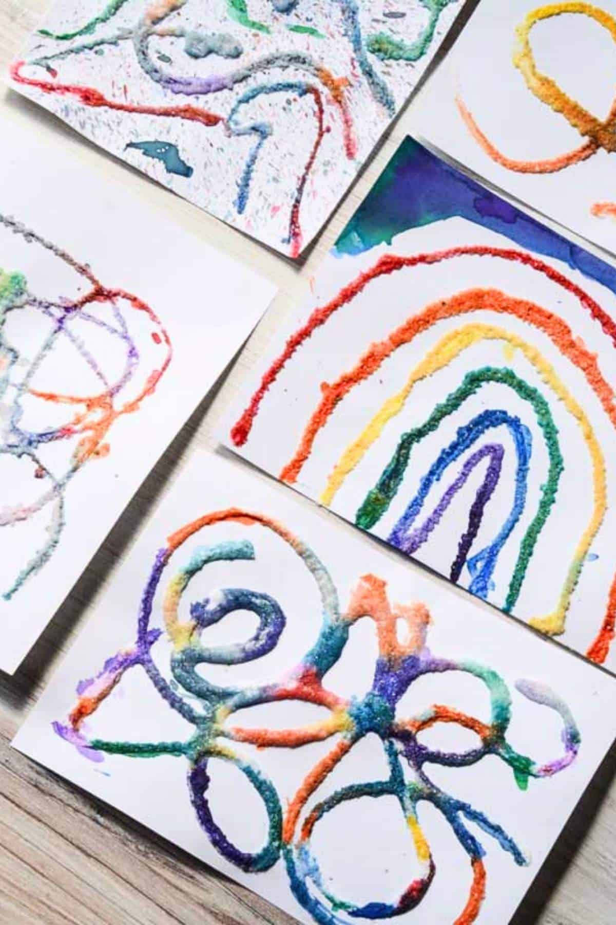 raised rainbow salt painting, abstract salt paintings on a table.