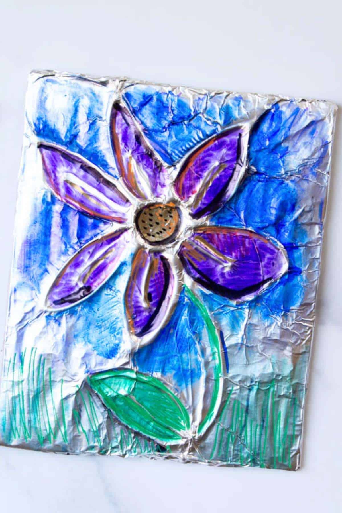 purple flower on a blue background created on foil.