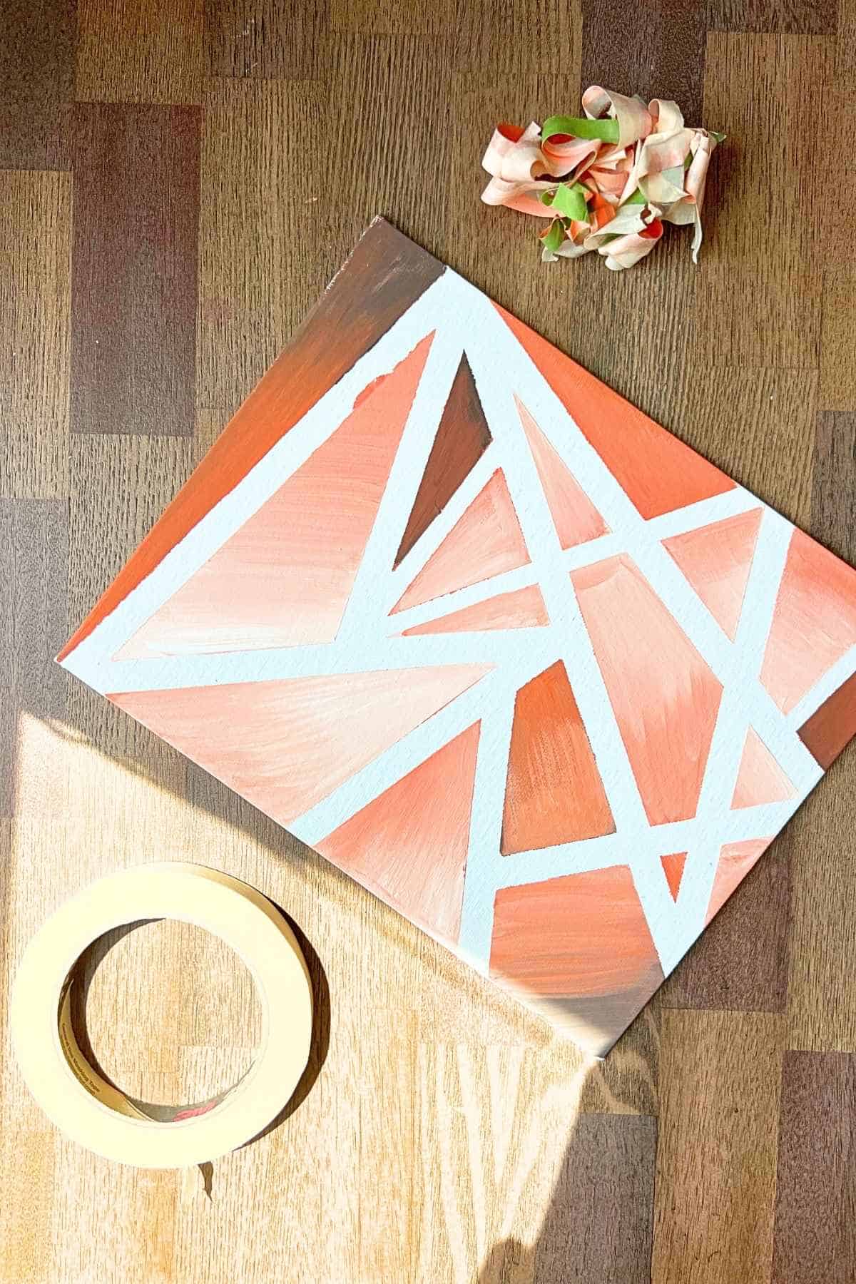 orange canvas abstract painting on a table.