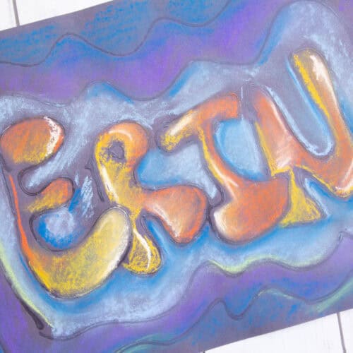chalk name drawing on black paper.