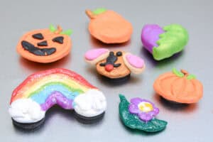 colorful clay magnets on a silver fridge.