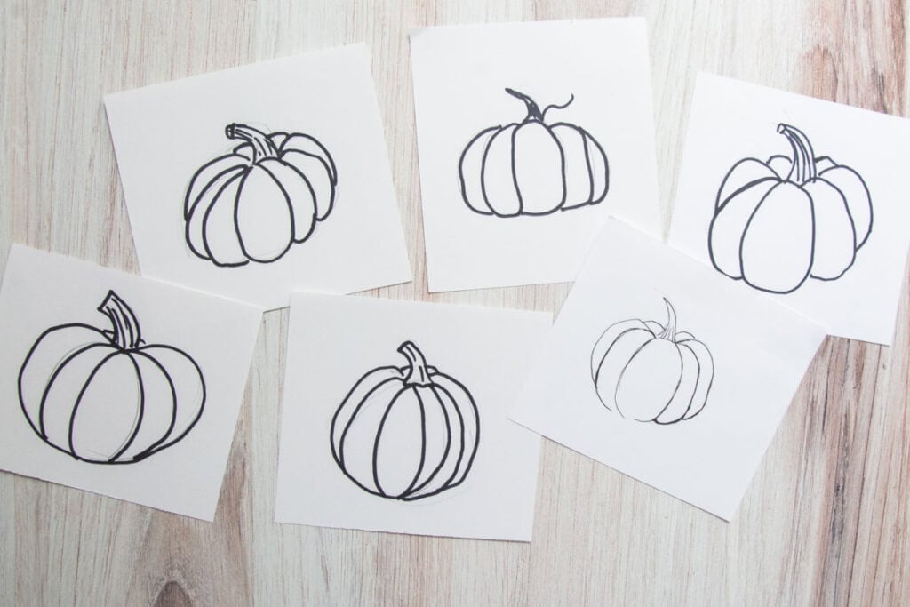 pumpkin line drawings on wood table.
