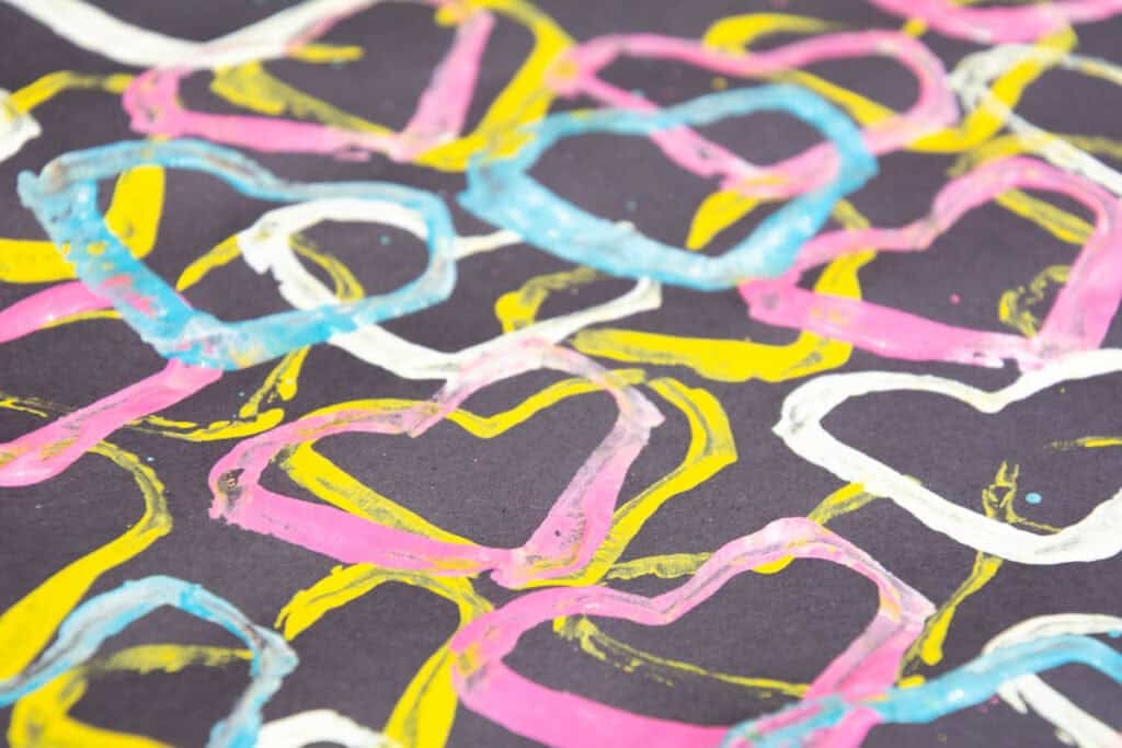 stamped colored hearts on black paper.