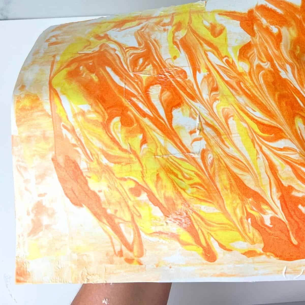 hand holding shaving cream paper marbled.