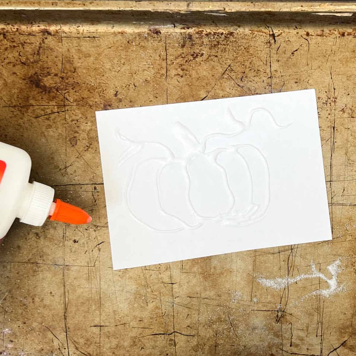 glue drawn pumpkin on white paper.