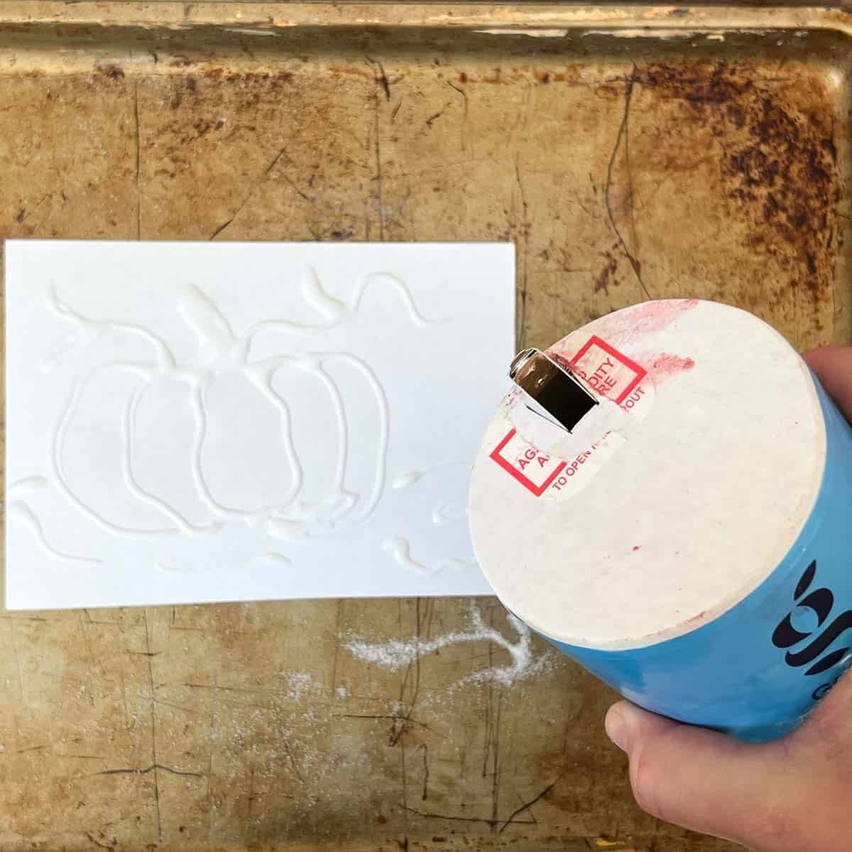 hand pouring salt onto glue drawing.