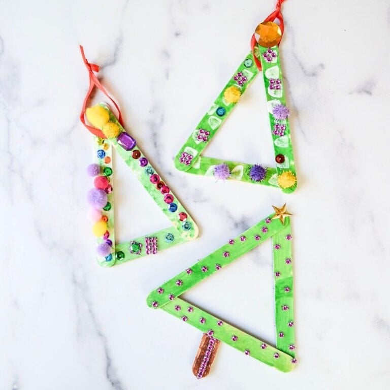 3 popsicle stick Christmas tree ornaments with decorations.