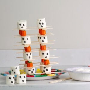 candy pumpkins, marshmallows and popsicle sticks stacked.