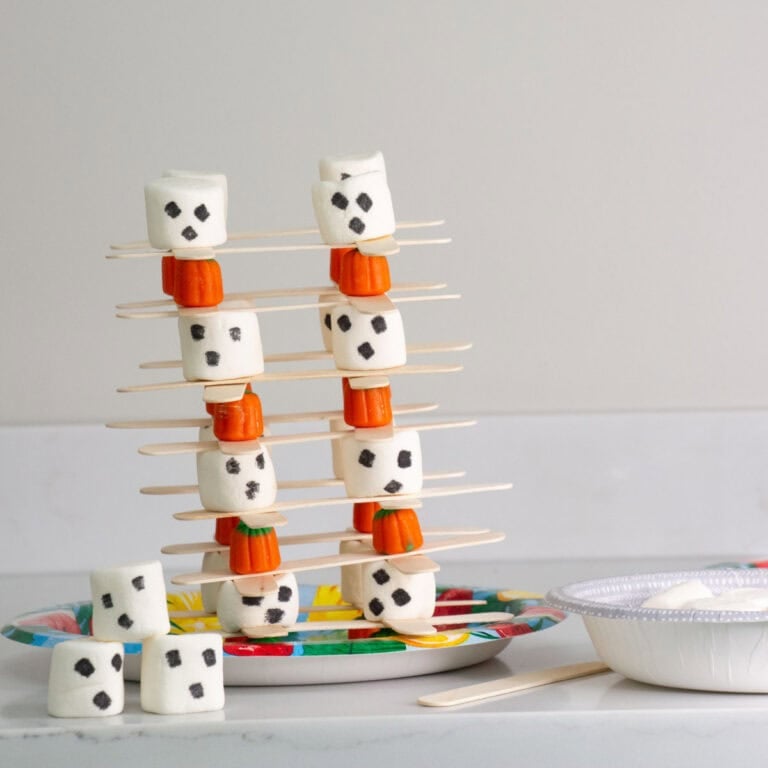 candy pumpkins, marshmallows and popsicle sticks stacked.