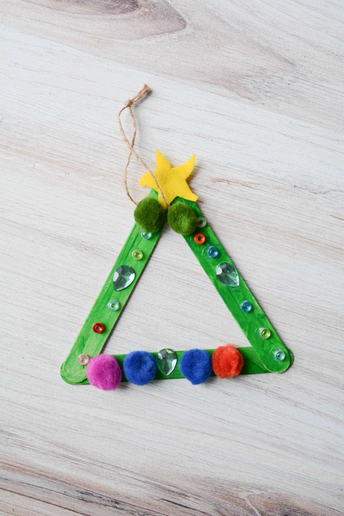 popsicle stick Christmas tree ornament with decorations.