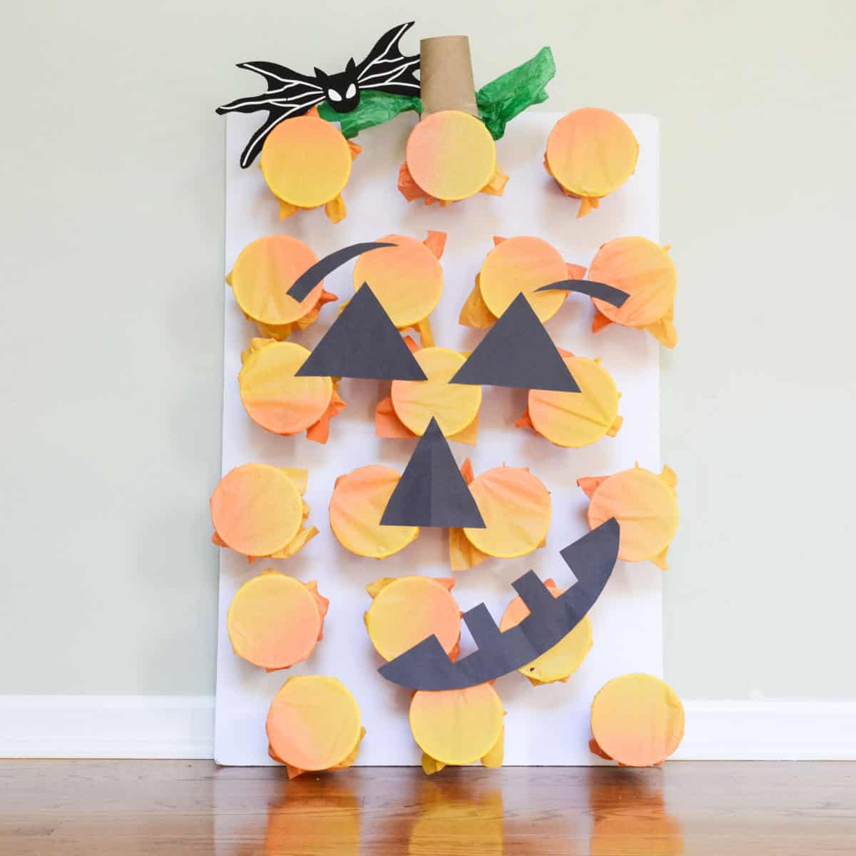 pumpkin cup board with jack-o-lantern face.