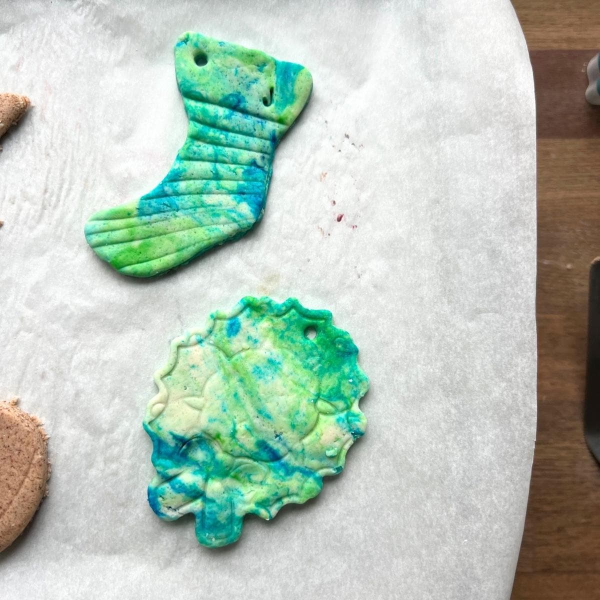 green and blue dyed ornaments on baking tray.