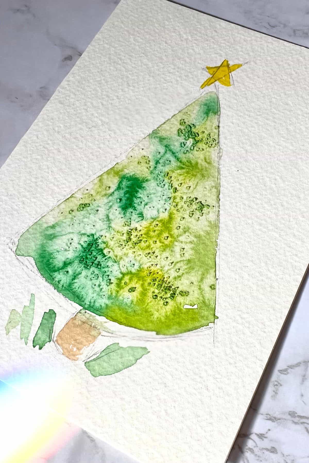 simple tree painted with salt in the watercolor paint.