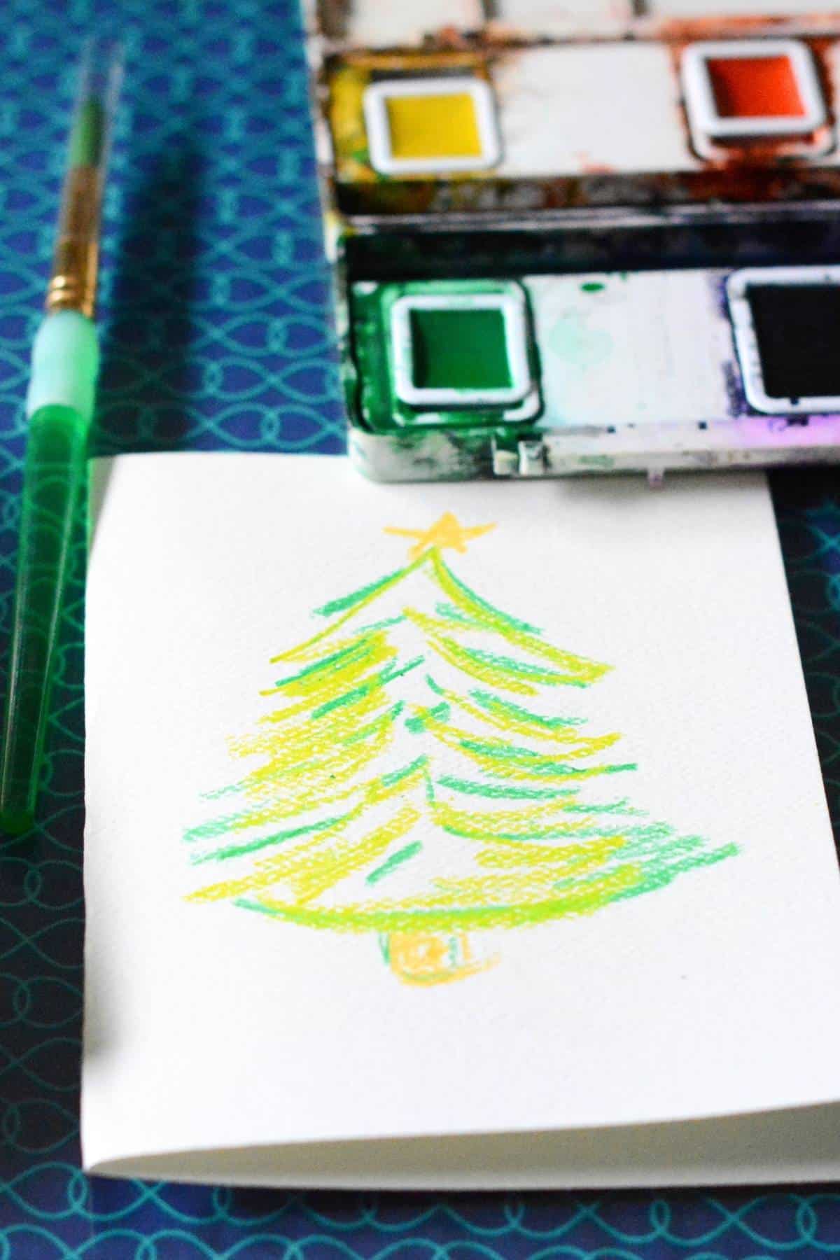 crayon drawing of Christmas tree on a card.
