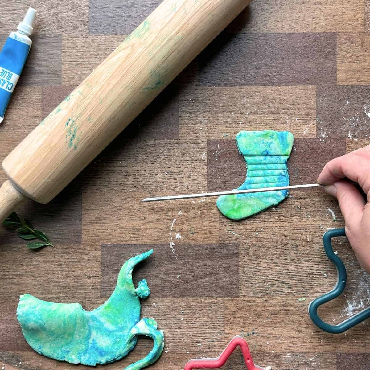 hand using skewer to add texture to salt dough ornament.