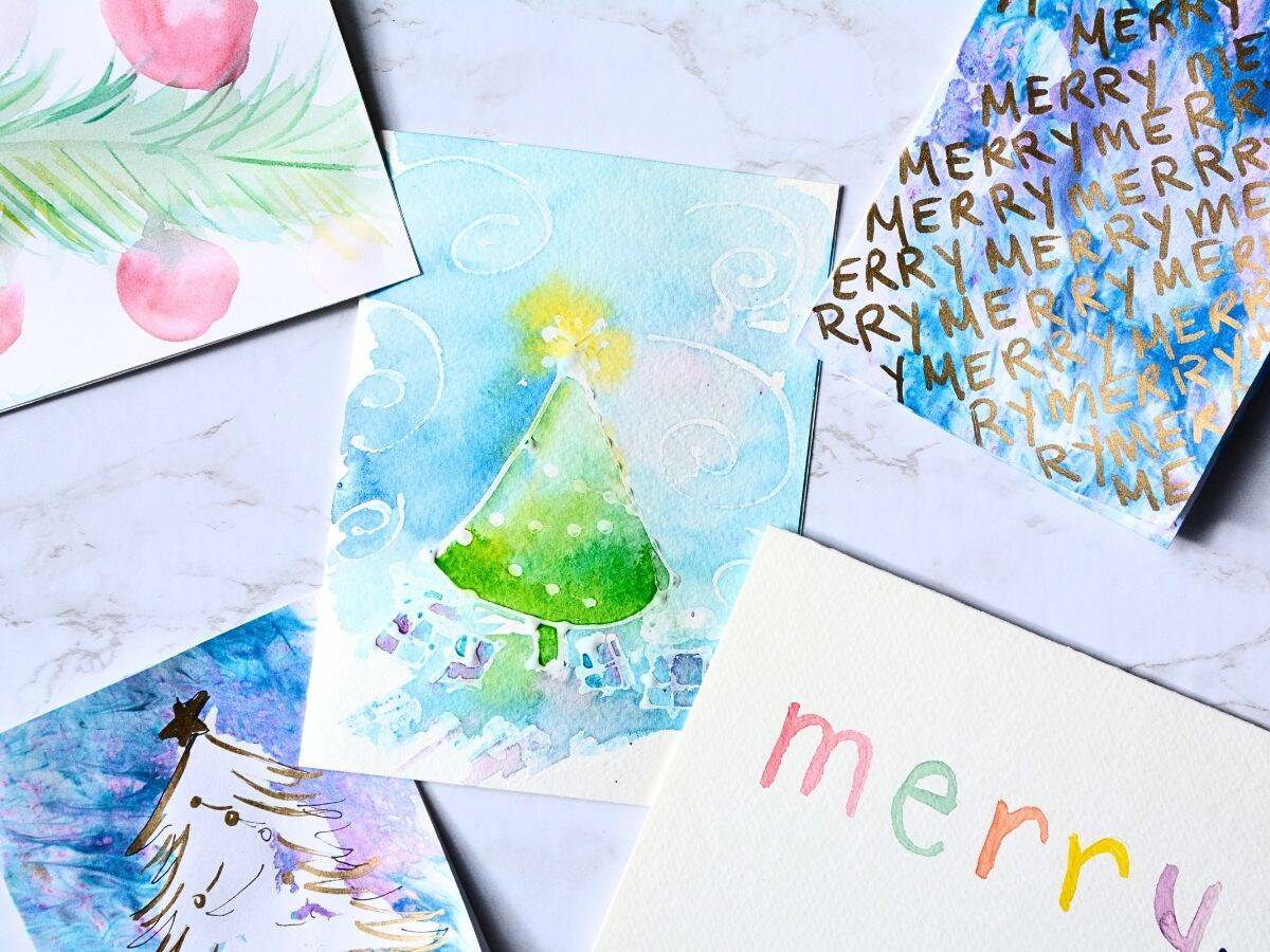 Hand painted Christmas cards on a table.