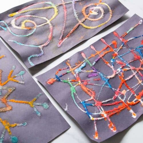 raised salt paintings on black paper.